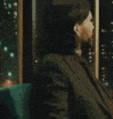 a man in a suit and tie is smiling with his eyes closed .