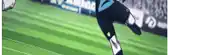 a soccer player is kicking a ball on a soccer field .