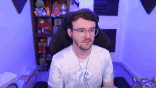 a man wearing glasses and a tie dye shirt looks at the camera