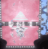 a group of girls are standing on a stage with a pink background