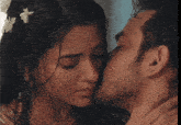 a man kissing a woman on the cheek with a nose ring