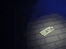a small electronic device is on a brick floor