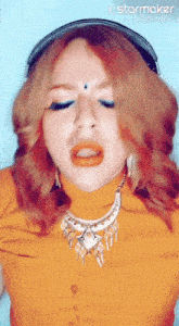 a woman wearing a hat and a necklace with keys on it