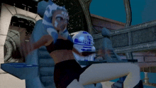 a woman in a black bra is sitting next to a robot that says r2d2 on it