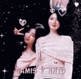 a couple of women are standing next to each other and making a peace sign .
