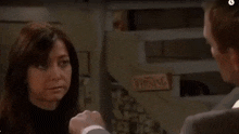 a man and woman are having a fight in a room .
