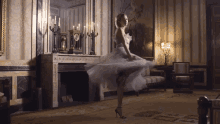 a woman in a white dress dancing in a living room
