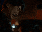 a man with a mustache is crying and looking down