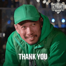 a man wearing a green hat and a green jacket says thank you