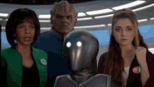 a group of people standing next to a robot with a badge that says ecg