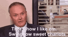a man in a suit and tie says that 's how i like em swing low sweet chariots .