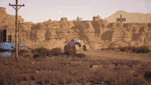 a monster truck is driving on a dirt road