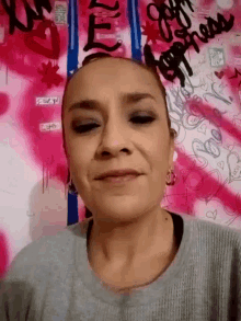 a woman 's face is shown in front of a pink background that says ' i love you '