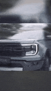 a ford truck is driving down a road