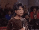 a woman is holding her head with her hands while screaming .