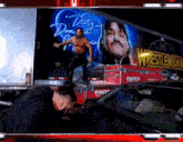 a wrestler is standing in front of a truck that says wrestlemania