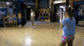 a girl is taking a picture of a group of people in a dance studio .