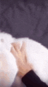 a blurry picture of a person 's hand touching another person 's chest