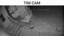 a black and white photo of a snowy patio with the words tim cam written above it