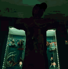 a person is standing in front of a display case with a blue light on it