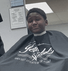 a boy is getting his hair cut by a greatest stylists in the world cape