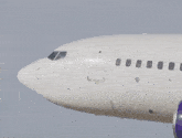 a man is sitting in the cockpit of a white airplane