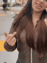 a woman is giving the middle finger while wearing a jacket
