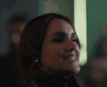 a close up of a woman 's face smiling