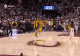 a basketball game is being played in front of a sign that says sherman williams