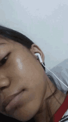 a close up of a woman wearing earphones .