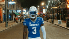 a football player wearing a blue memphis jersey with the number 3 on it