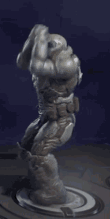 a statue of a man with a helmet on is standing on a circle