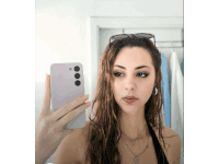 a woman is taking a picture of herself in the mirror