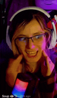 a woman wearing glasses and headphones is smiling in front of a microphone with the words soup 22h ago on the bottom