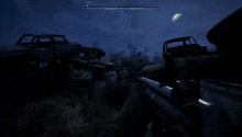 a person is holding a gun in a video game at night