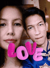 a man and a woman are posing for a picture with the word love on the bottom