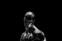 a silver statue of a man against a black background with stars in the background