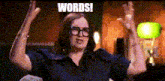 a woman wearing glasses is raising her arms in the air with the words words written on the bottom