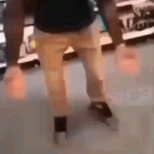 a blurry picture of a man 's legs and feet dancing in a store .