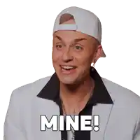 a man wearing a white baseball cap and a white suit says mine