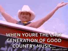 a man in a cowboy hat is riding in a boat with his arms outstretched