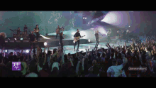 a group of people are playing instruments in front of a crowd with a sign that says learn to fly