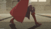 a woman in a red cape and brown boots is walking