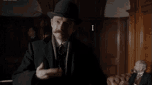 a man with a hat and mustache is holding a potato and says i am glad you liked my potato