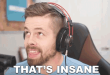 a man wearing headphones with the words that 's insane on the bottom