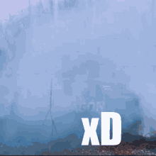 a man is smiling in front of a smokey background and the word xd is on the bottom