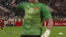 a man in a green shirt with the number 3 on it