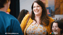 a woman in a yellow cardigan smiles while standing next to a girl in a nbc ad