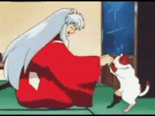 a man in a red robe is petting a cat .