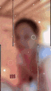 a blurred image of a person with the letter m in the middle